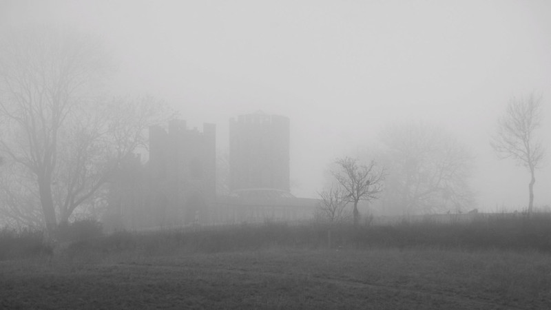 Lord Boston's Folly emerging through autumn fog in black and white