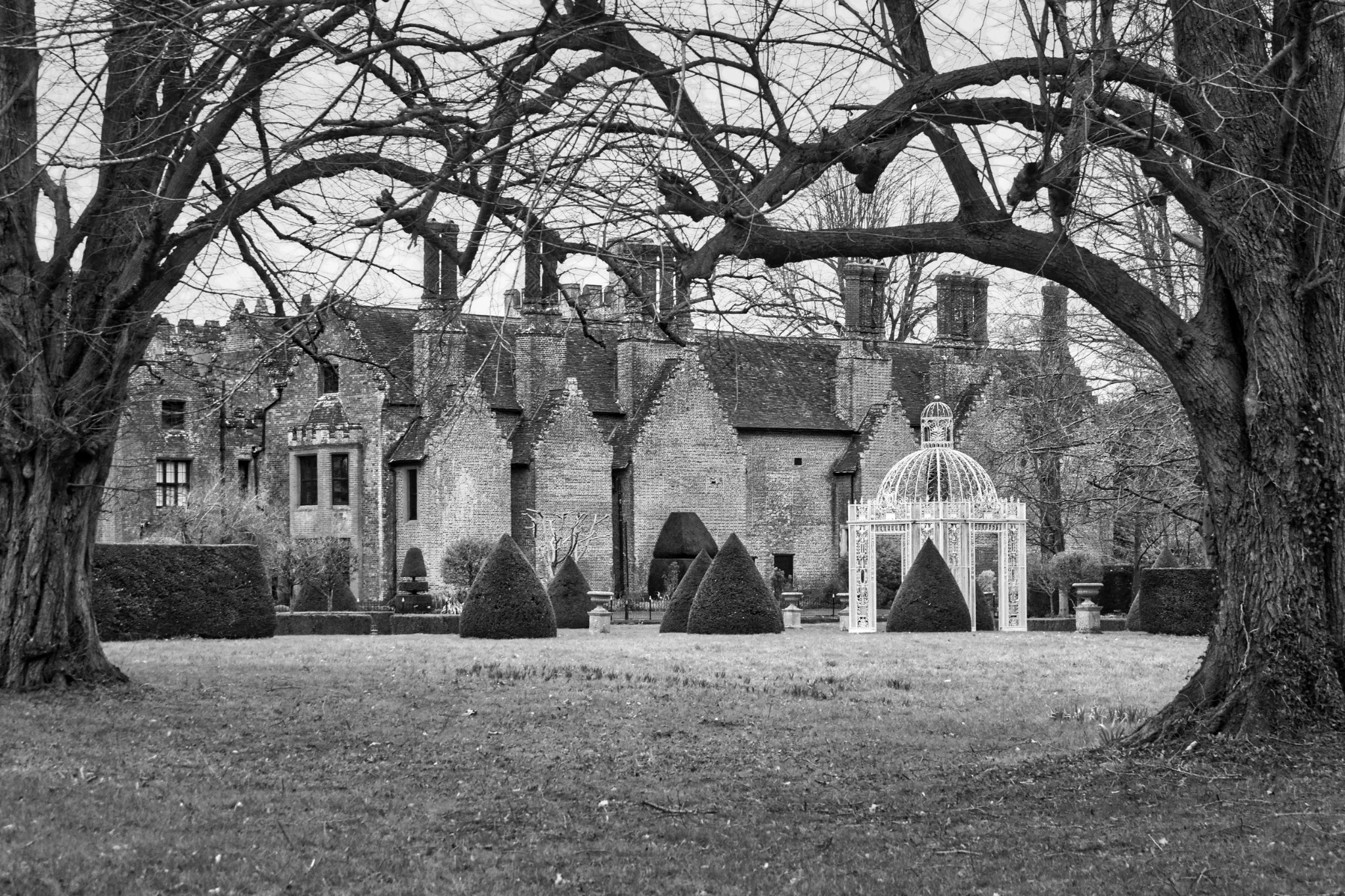 Historic manor house and formal garden in black and white