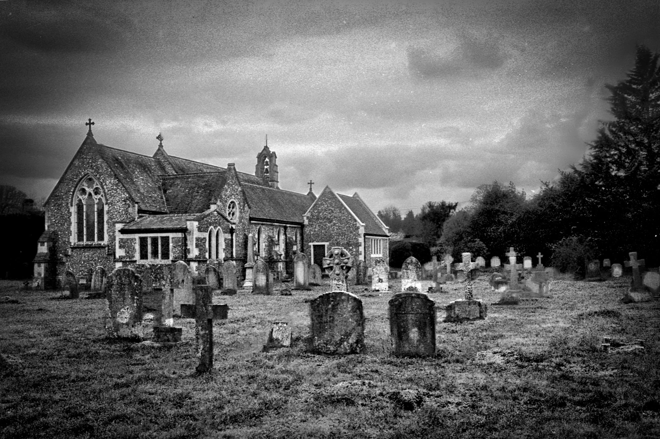 Rural church and graveyard photographed in black and white