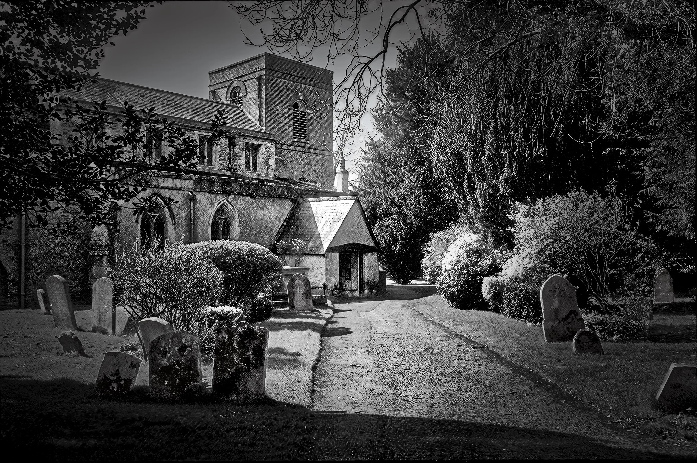 English parish church and churchyard photographed in black and white