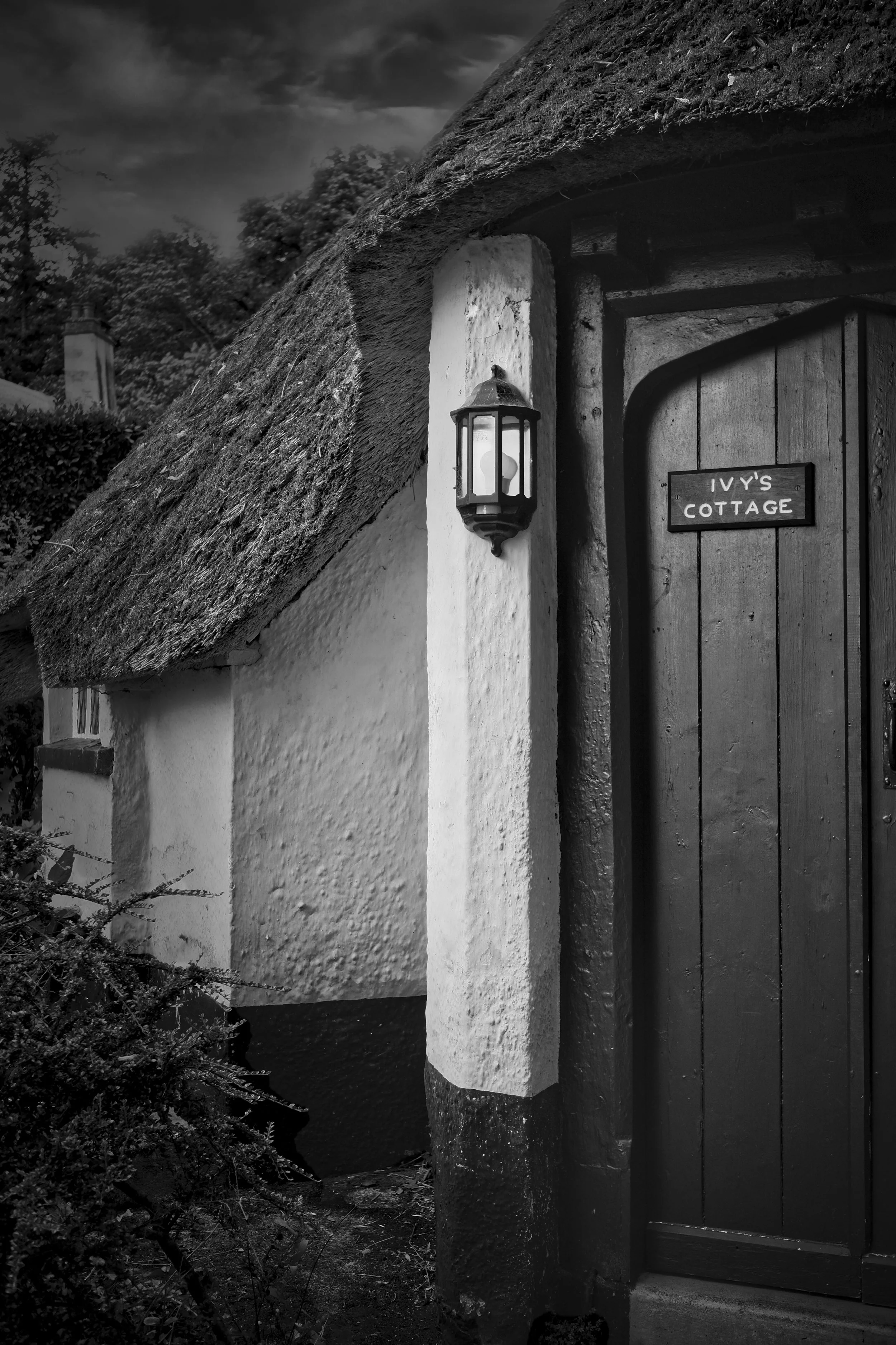 Thatched cottage doorway and architectural details photographed in black and white