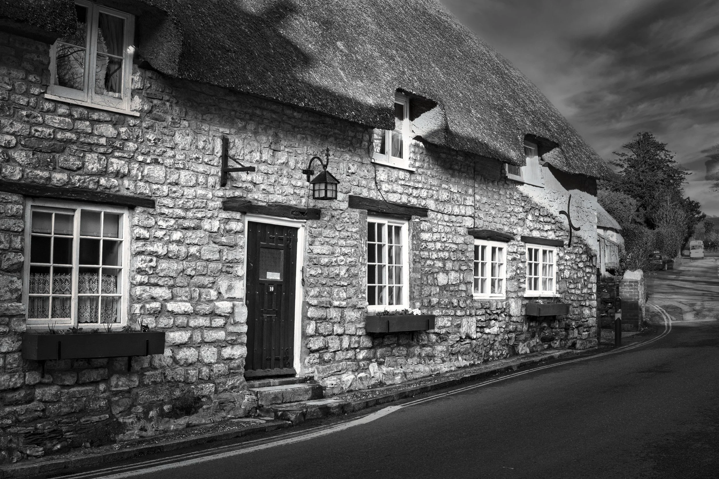 Traditional stone and thatched cottage photographed in black and white