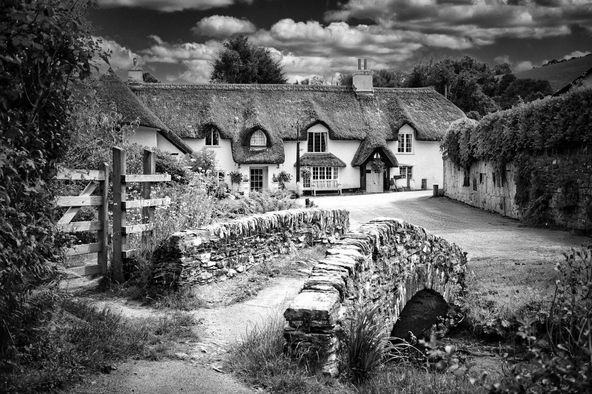 Stone bridge and thatched cottages in the English countryside