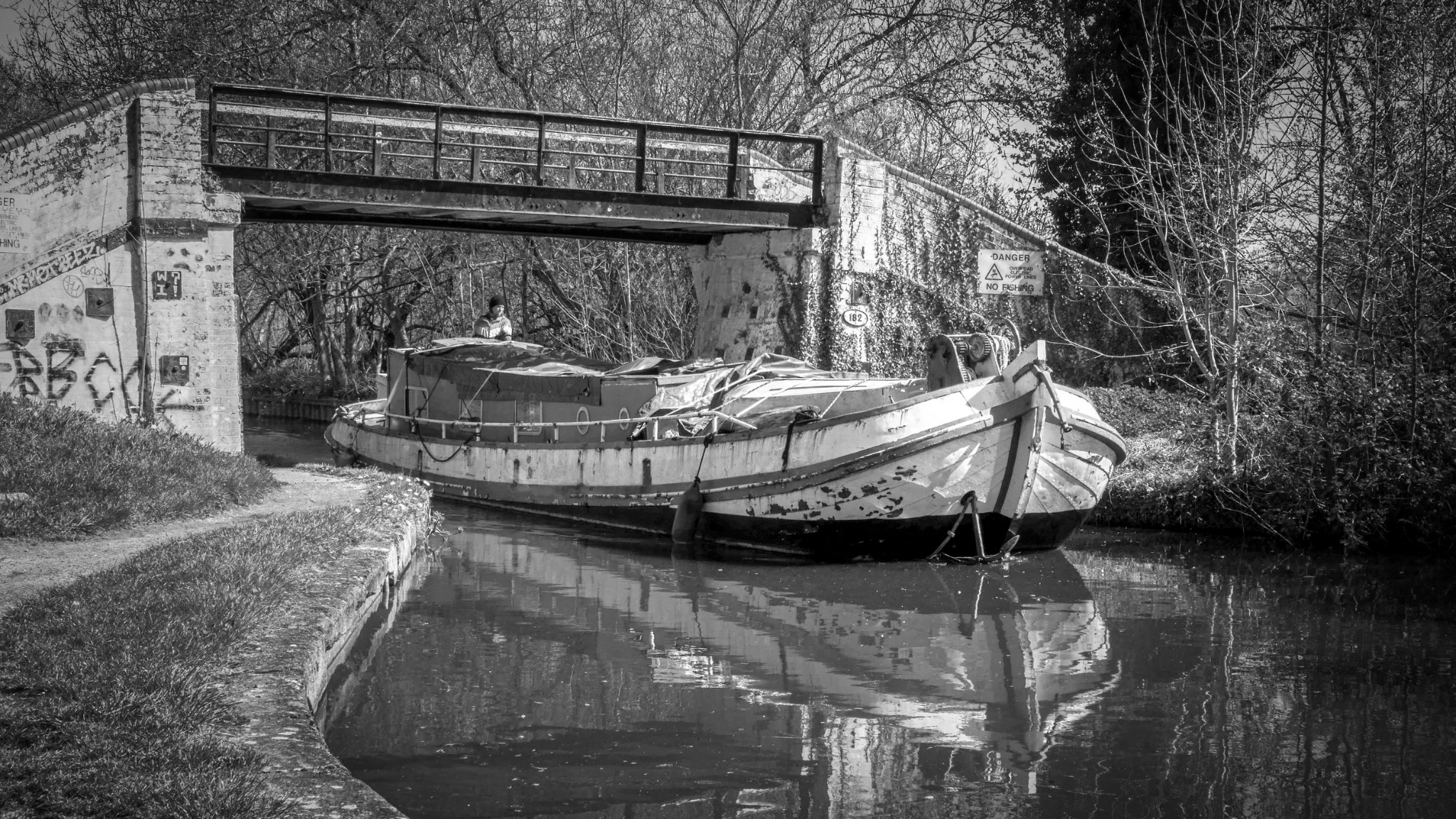 Canal bridge with narrowboat in black and white