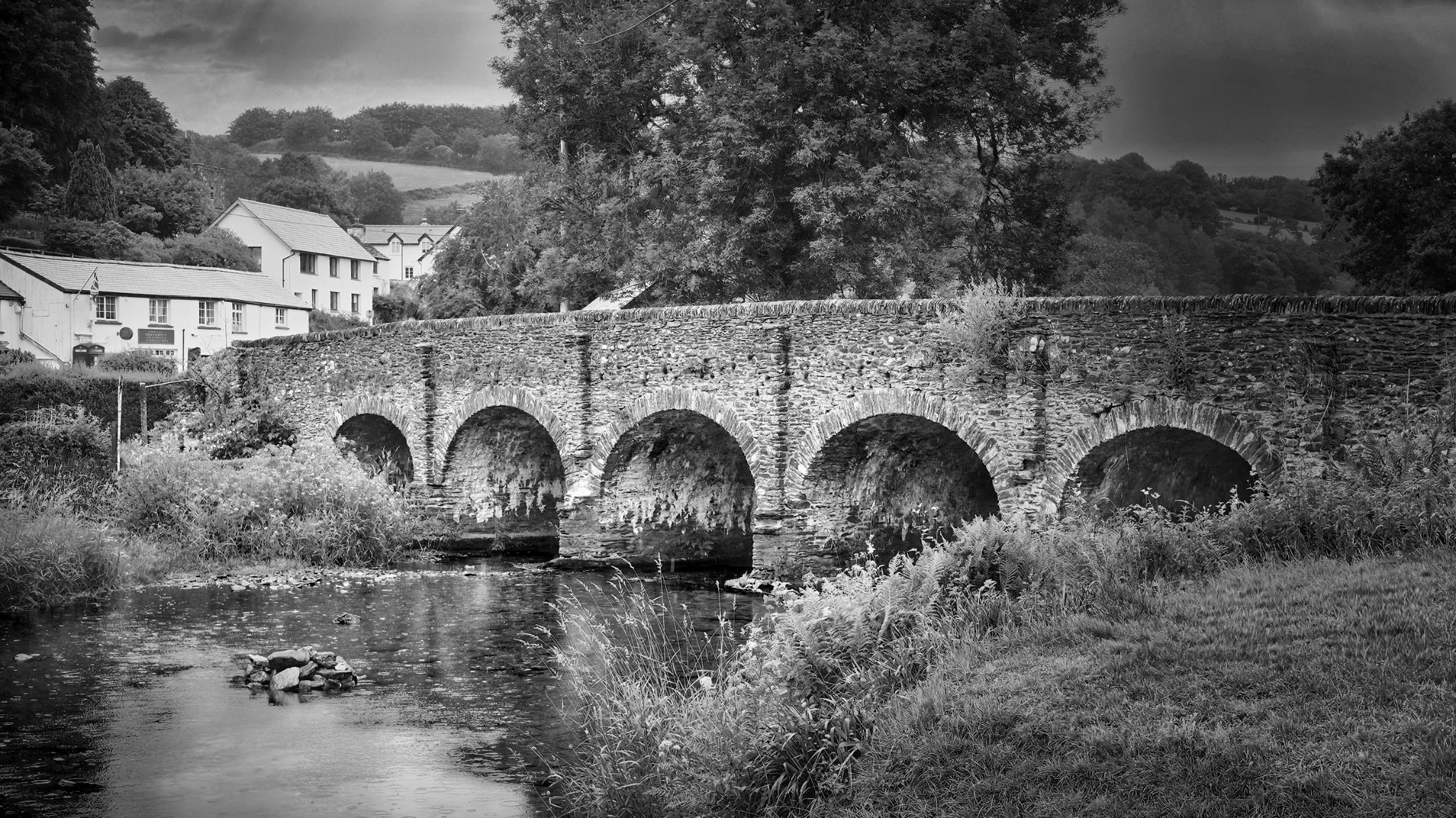 Old stone bridge in a village landscape