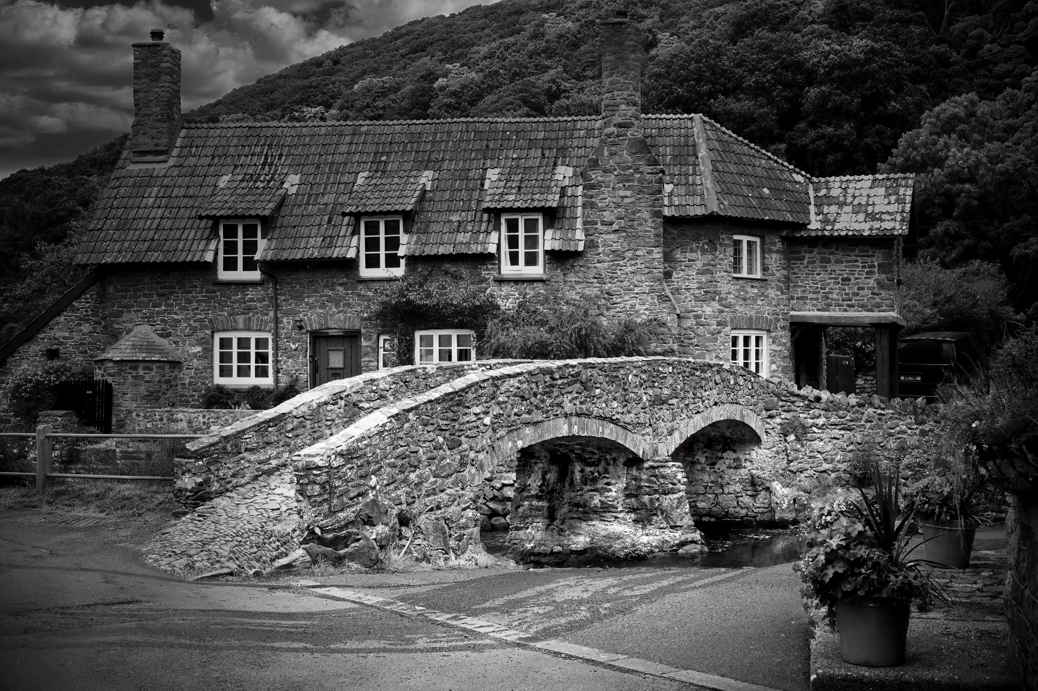 Historic stone bridge beside a cottage