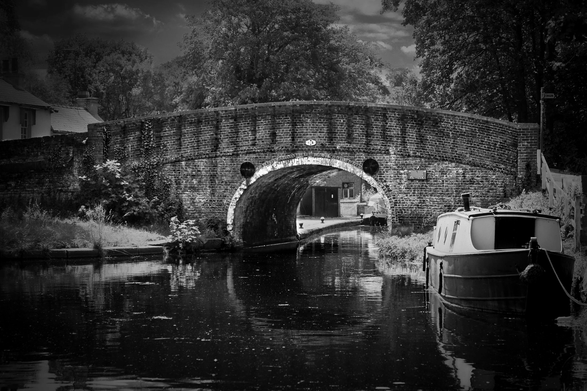 Canal bridge with boat and reflections