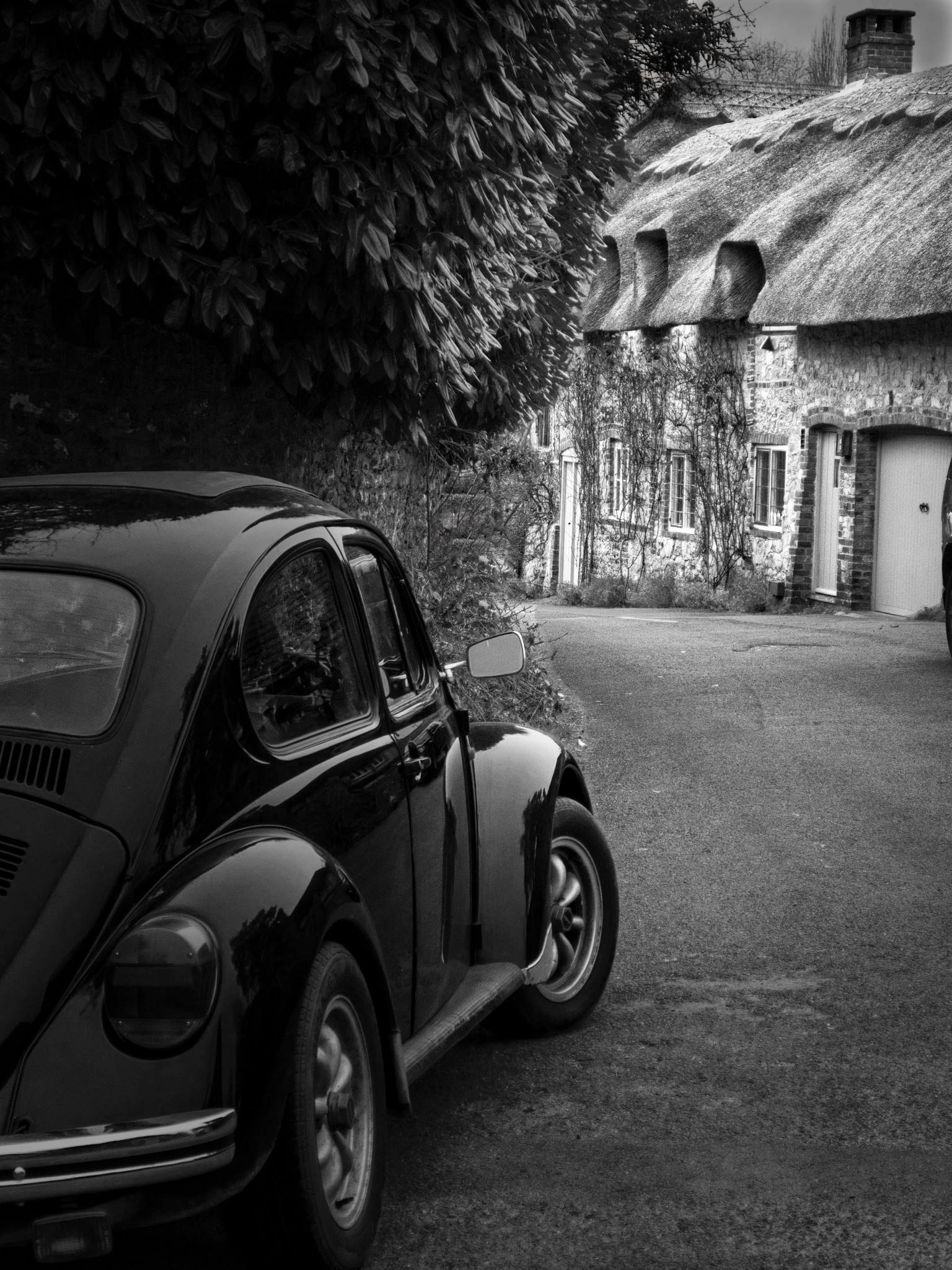 Thatched cottage with a classic Volkswagen Beetle