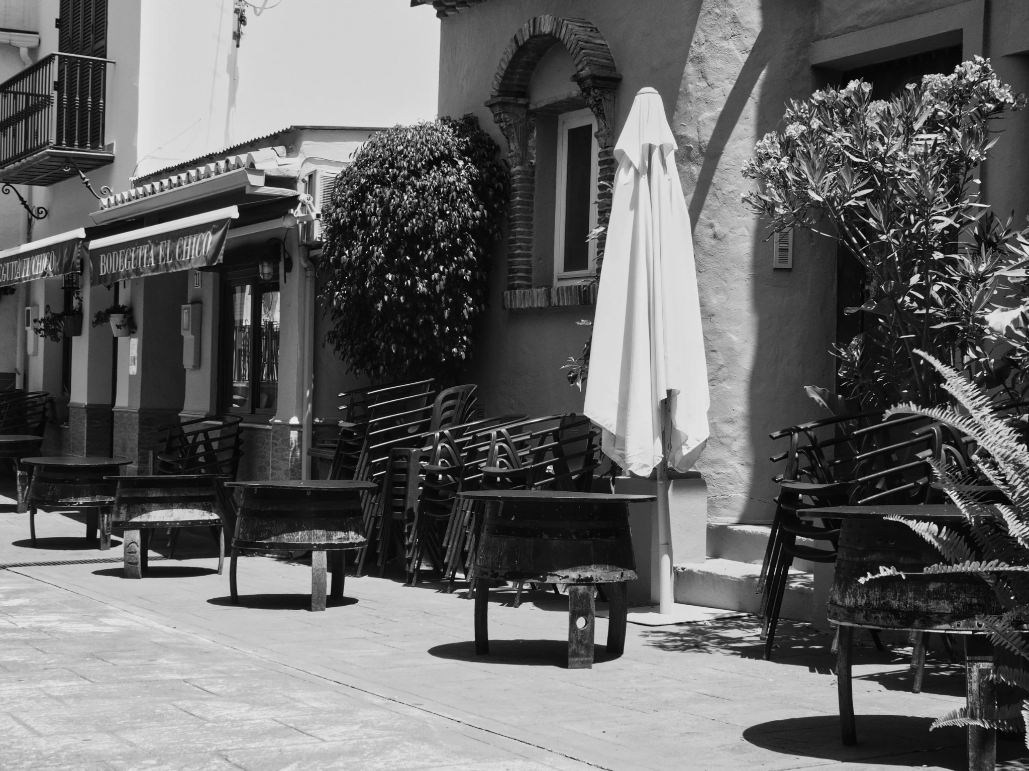 Bodeguita el chico bar stacked chairs parasol Benahavis andalusia