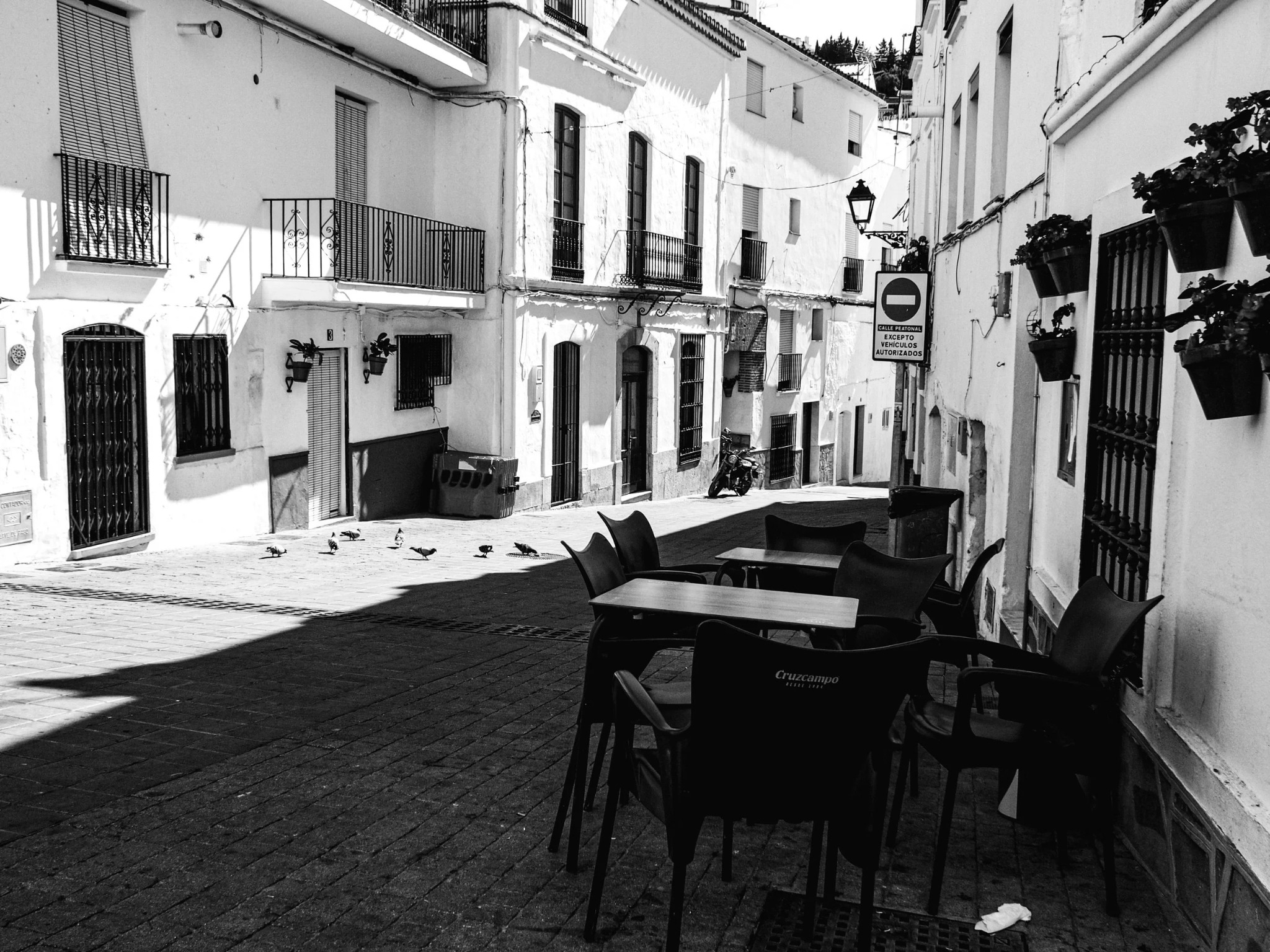 Siesta time andalusia spain empty chairs and streets street photography urban observation photograph