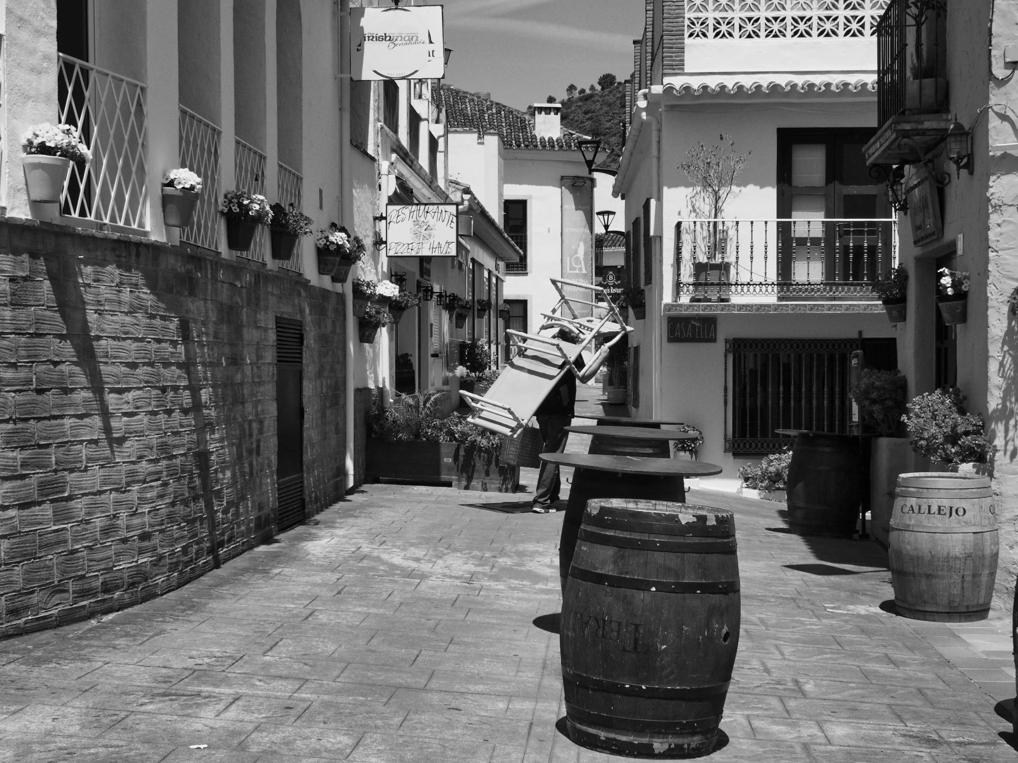 Wine barrels street worker restaurant Benahavis andalusia village