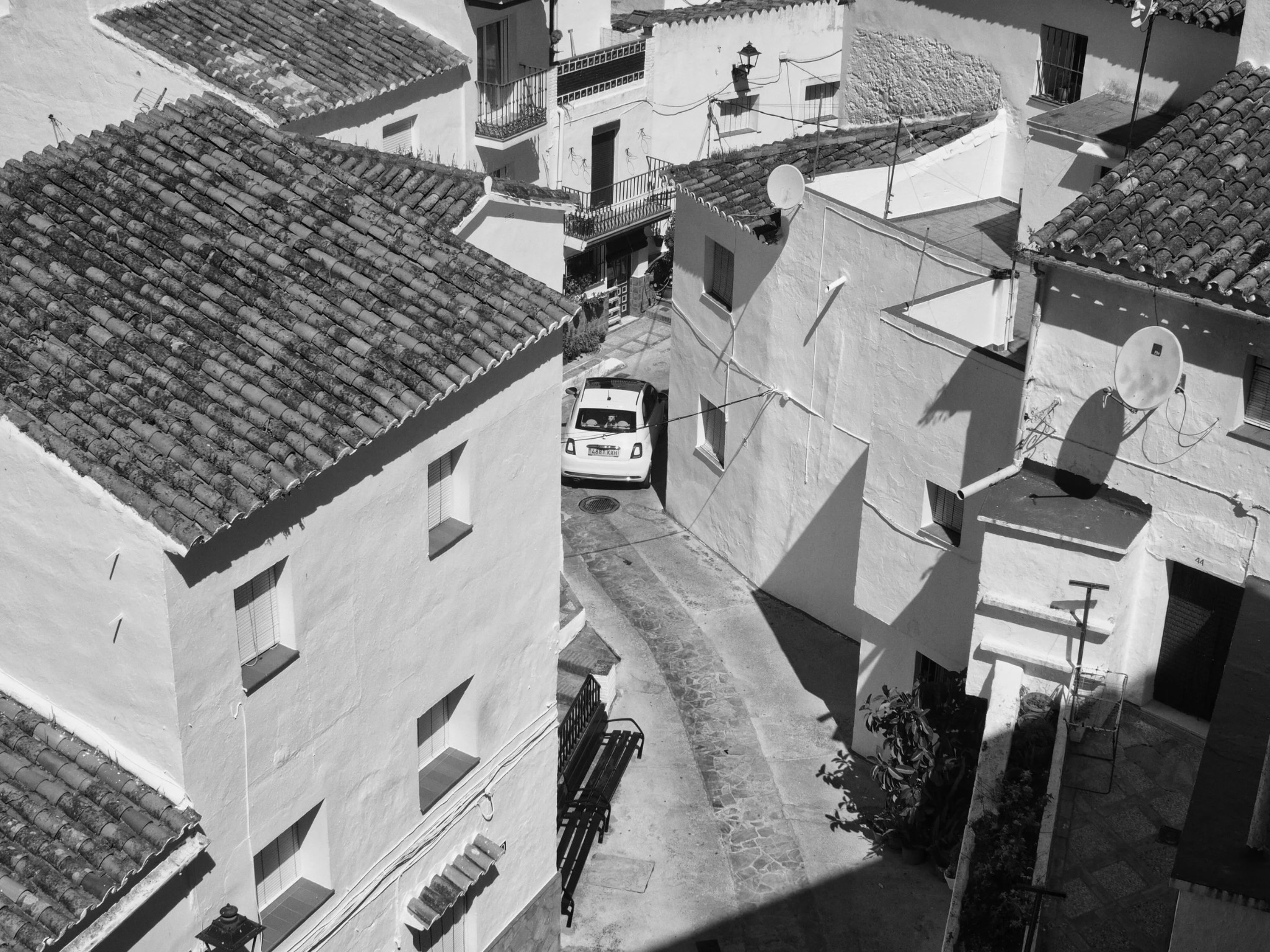 Casares village street white car