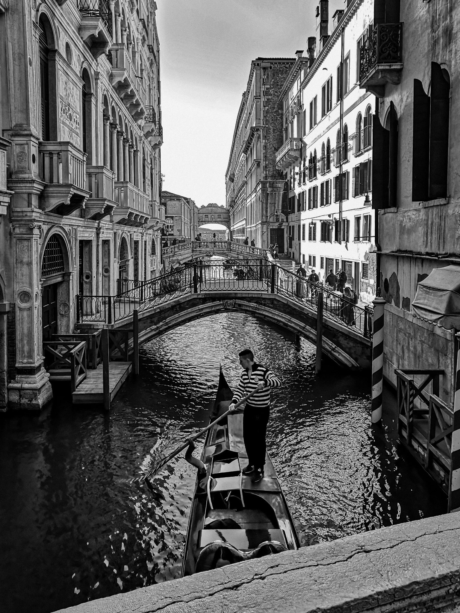 Venice gondolier narrow canal black and white