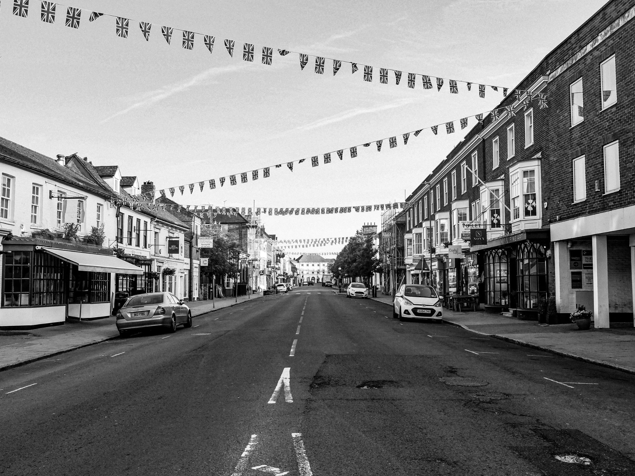 Empty high street with bunting in black and white
