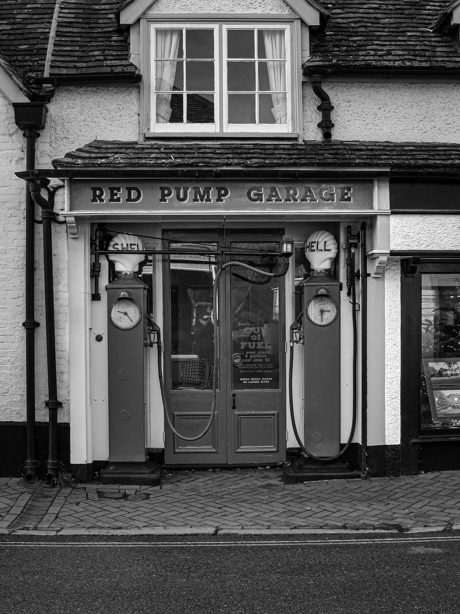 Red Pump Garage with vintage petrol pumps in black and white